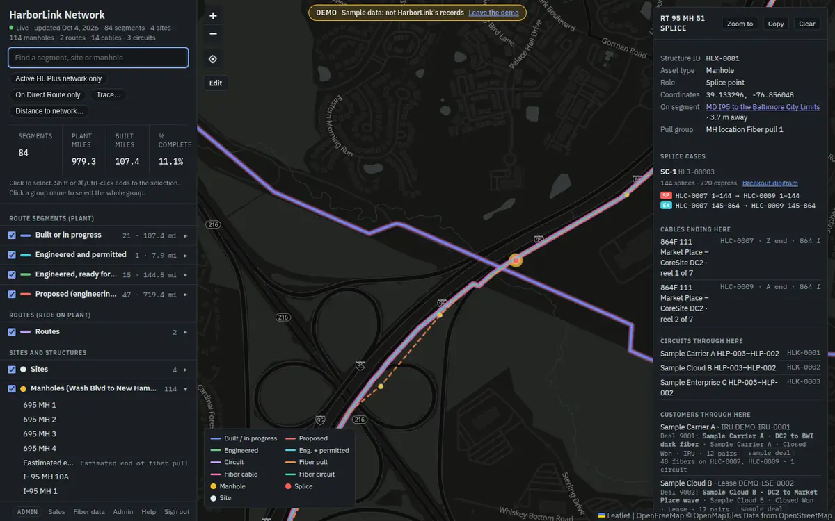 The map in dark mode: a dark grey basemap, the same coloured lines, and a dark selection panel showing a splice manhole.